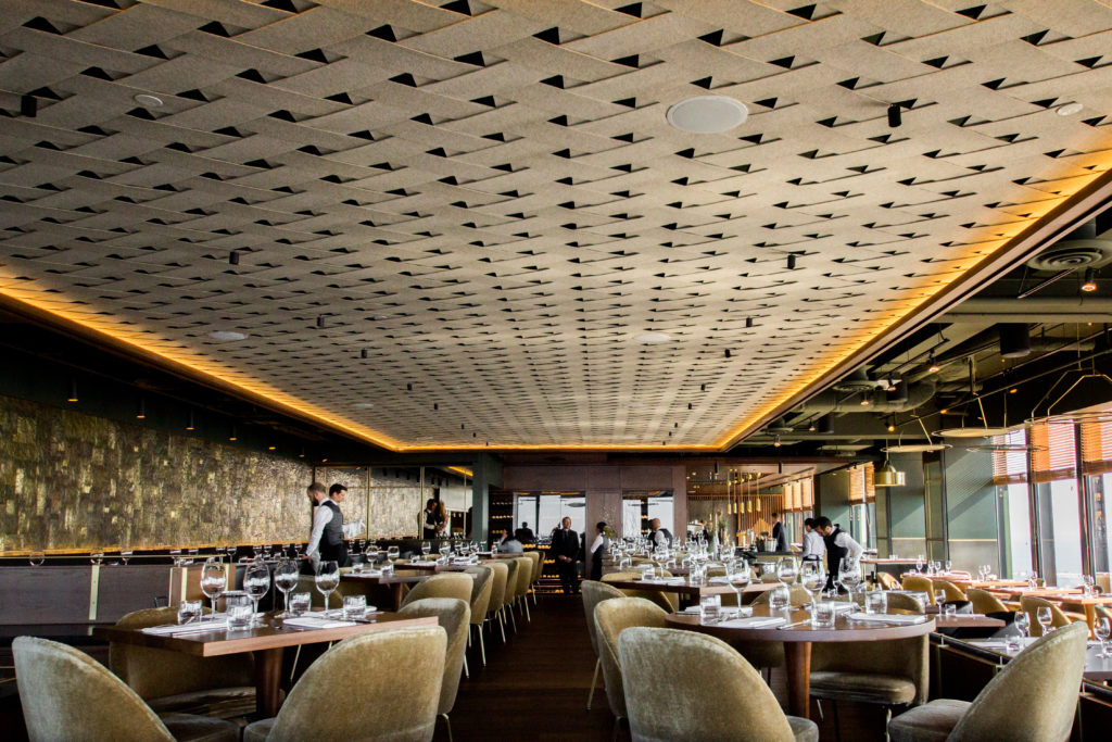 Canoe interior with woven ceilings and servers cleaning tables